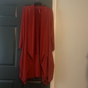 Long (below the knee) cardigan/jacket. Polyester heavy drape. Pumpkin color